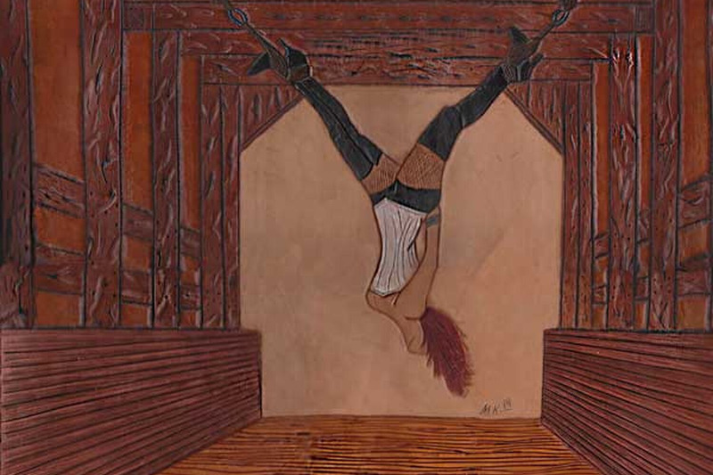 Woman in Upside Down Suspension in Leather Carving